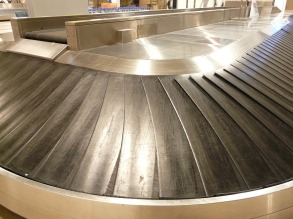 an empty baggage claim conveyor belt at an airport